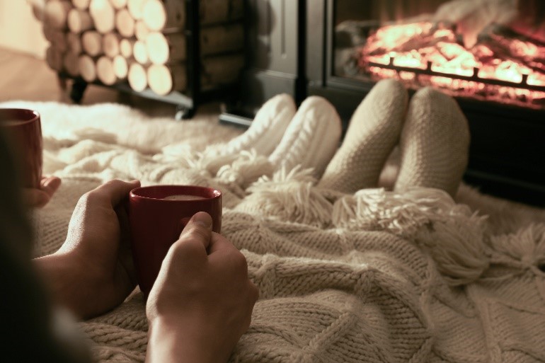 drinking hot chocolate in front of the fire place